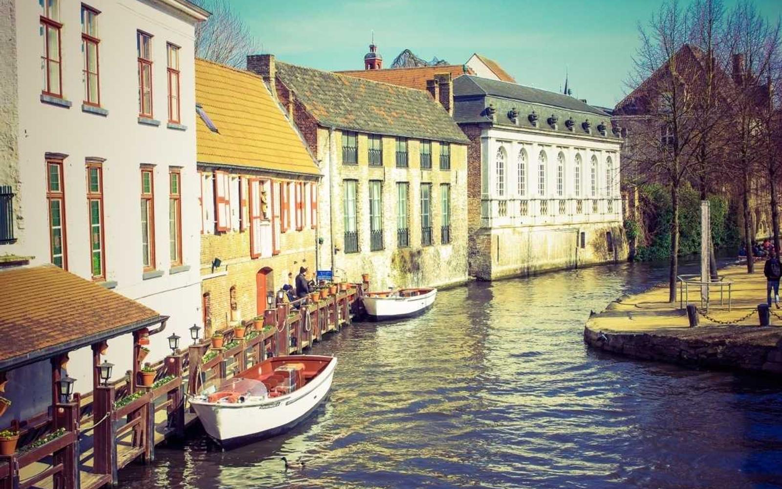 A working harbor — boats moored against the waterfront, the urban meeting the ocean.